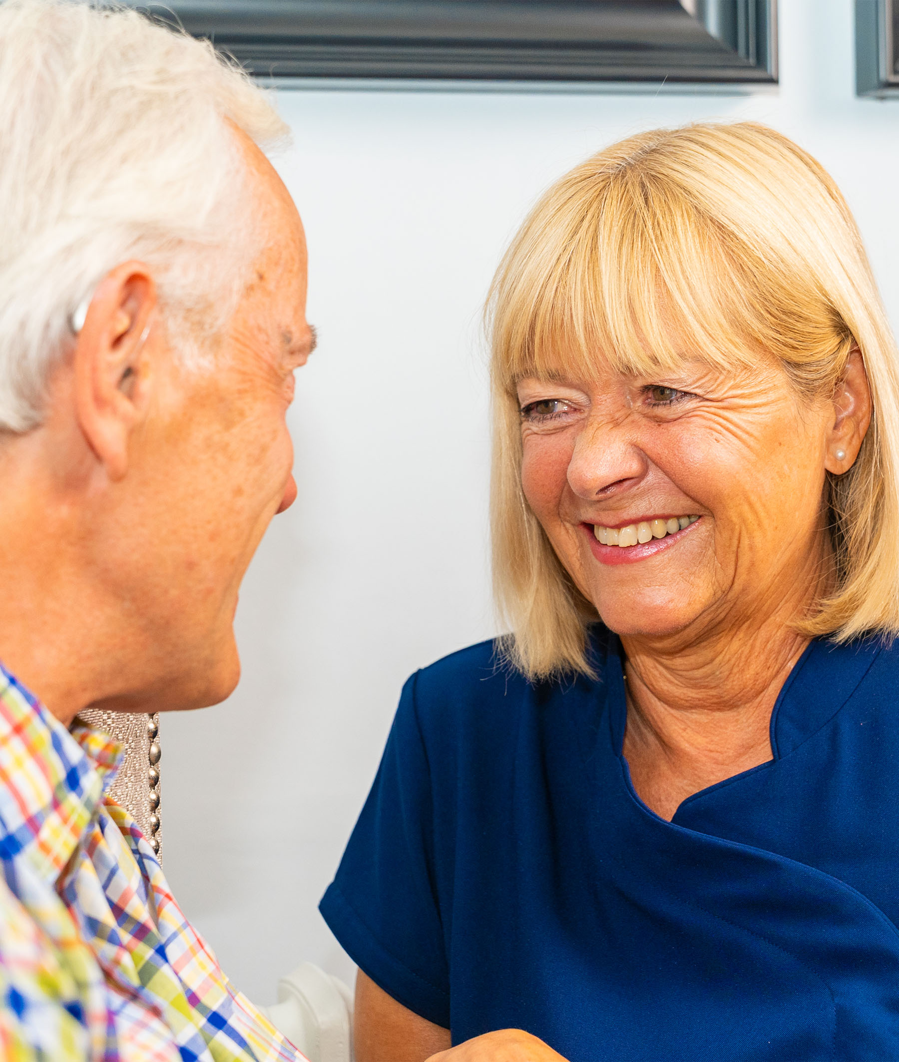 Image of resident and carer smiling at each other 