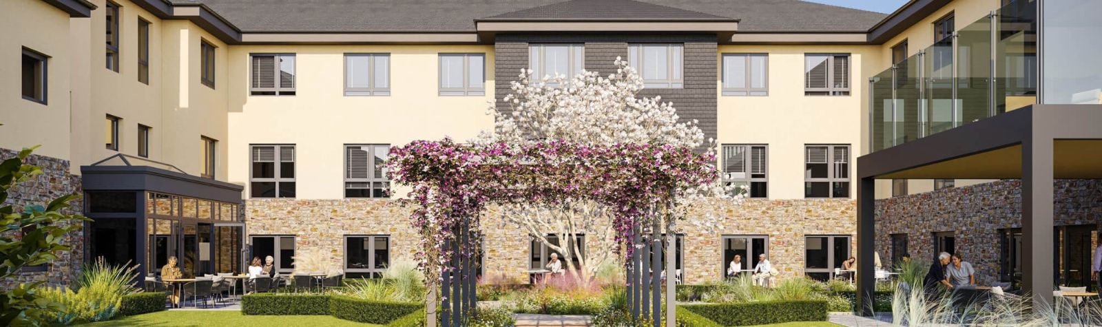 A modern purpose built care home with a welcome garden area at the forefront with people relaxing outside